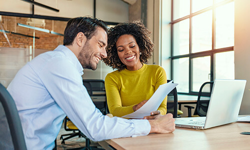 two business colleagues looking at paperwork