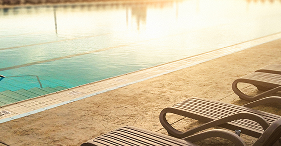 Lounge chairs next to a pool