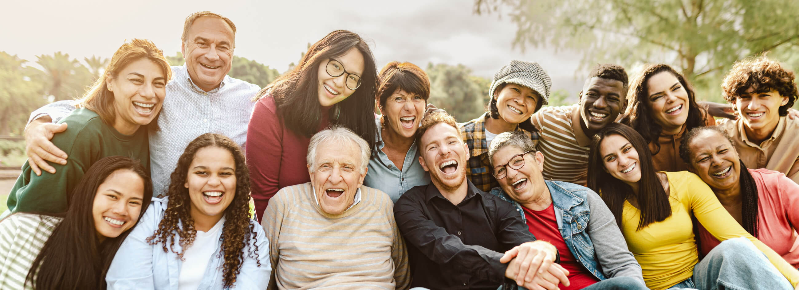 a group of people sitting on the grassy ground